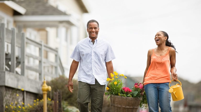 couple walking and holding flowers