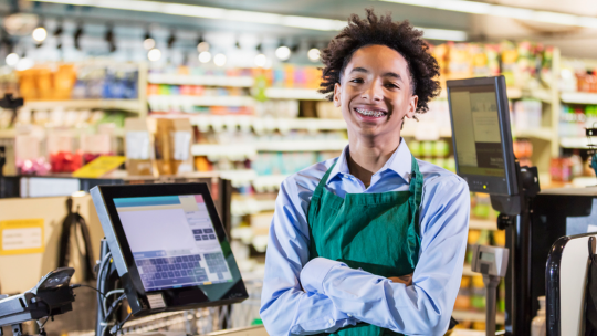 teenager at cash register