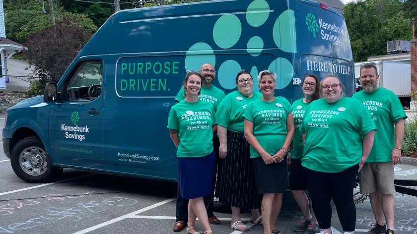 The Newmarket team poses in front of the Kennebunk Savings van at their customer appreciation event